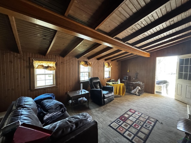 living room with beam ceiling, wood ceiling, wood walls, and carpet flooring