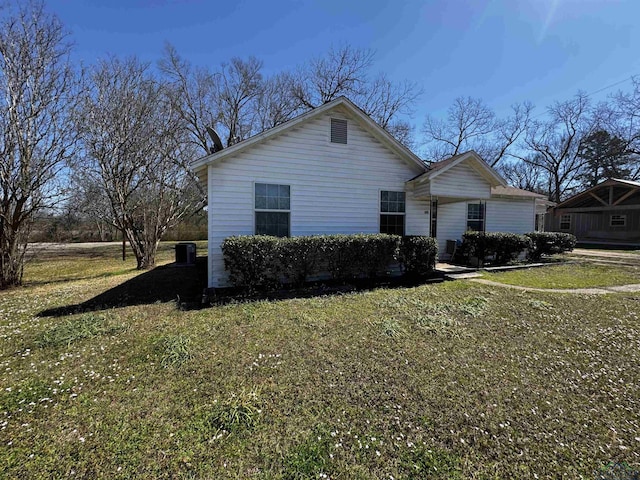 view of home's exterior with a lawn