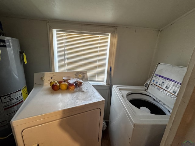 washroom featuring electric water heater, laundry area, and washing machine and clothes dryer