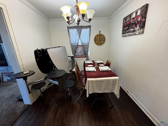 dining room with wood finished floors, baseboards, ornamental molding, a textured wall, and a chandelier