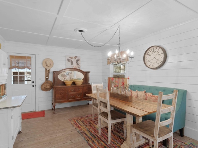 dining room featuring light hardwood / wood-style floors and a chandelier