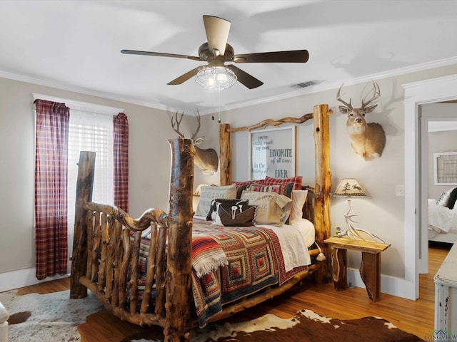 bedroom with crown molding, ceiling fan, and light wood-type flooring