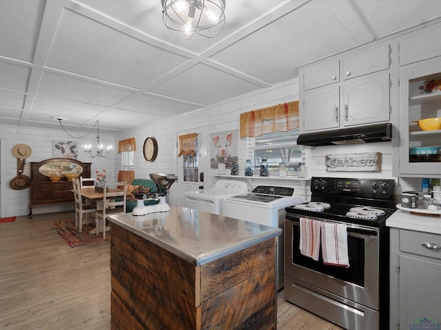 kitchen with coffered ceiling, white cabinetry, washer and dryer, a notable chandelier, and stainless steel electric stove