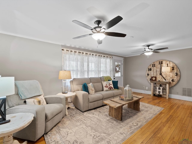 living room featuring ornamental molding and light hardwood / wood-style flooring