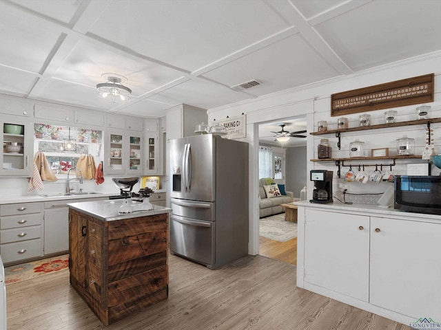 kitchen featuring a kitchen island, sink, coffered ceiling, light hardwood / wood-style floors, and stainless steel refrigerator with ice dispenser