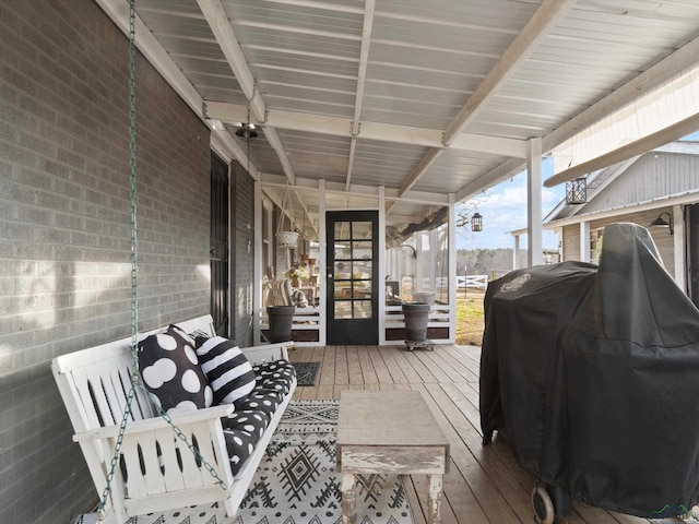 wooden deck with a grill