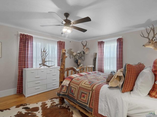 bedroom featuring crown molding, ceiling fan, and light hardwood / wood-style floors