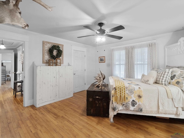 bedroom with crown molding and light hardwood / wood-style flooring