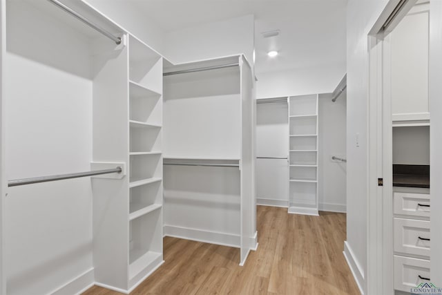 walk in closet featuring light hardwood / wood-style floors