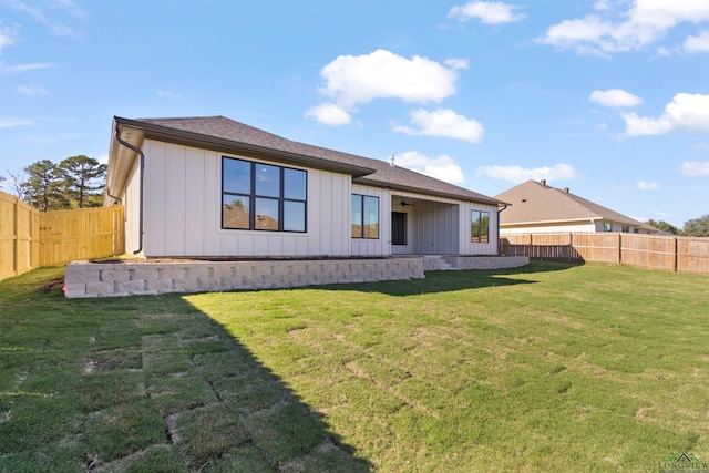 rear view of house with a yard