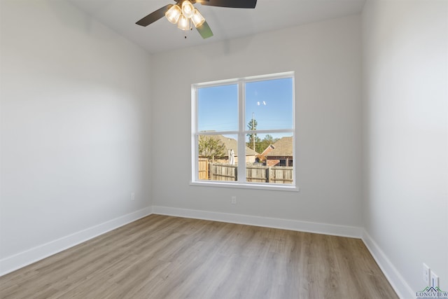 unfurnished room with ceiling fan and light wood-type flooring