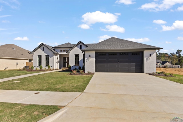 view of front of house featuring a front yard and a garage