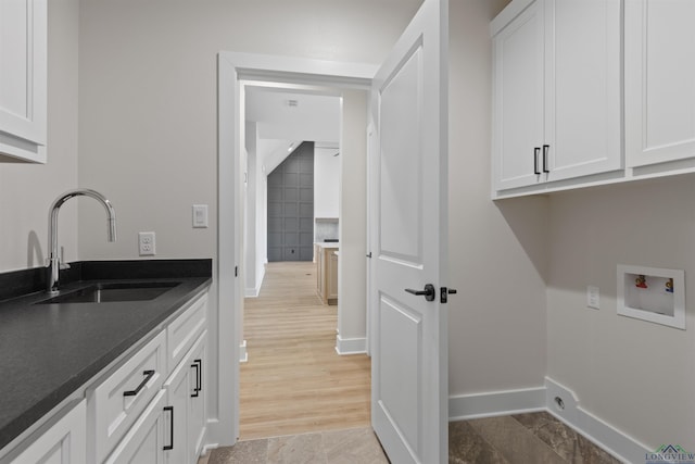 laundry area with cabinets, washer hookup, and sink