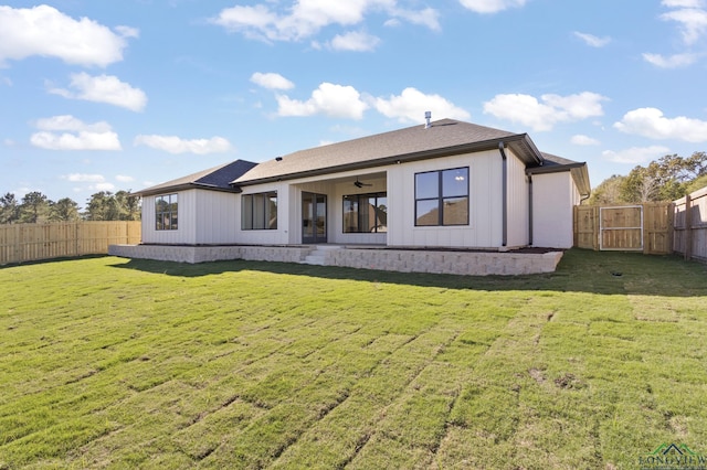 rear view of house featuring a yard