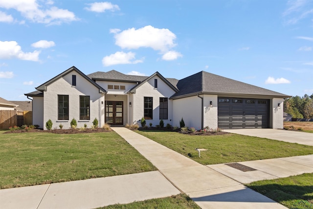 view of front of house with french doors, a front yard, and a garage