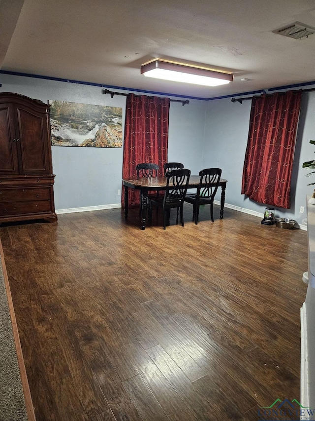 dining space with dark wood-type flooring