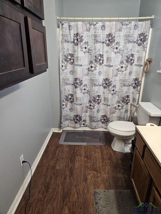 bathroom with vanity, wood-type flooring, and toilet