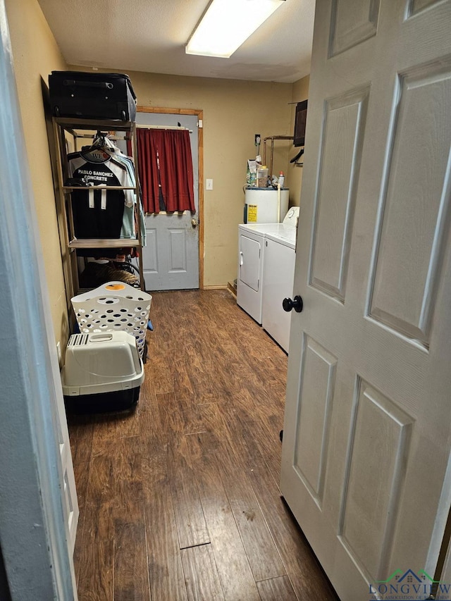 washroom with dark wood-type flooring and washer and dryer