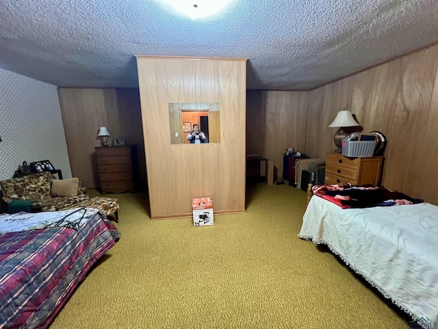 carpeted bedroom featuring a textured ceiling and wooden walls