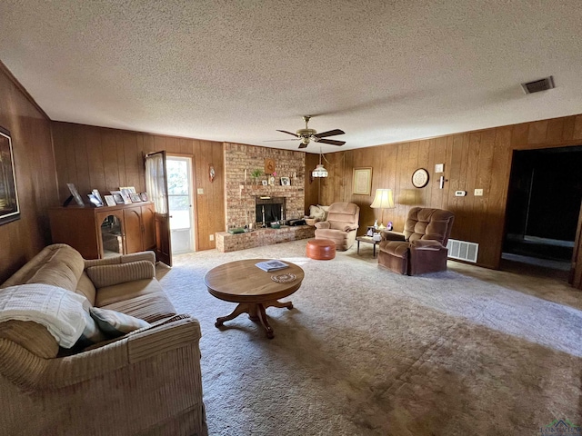 living room with ceiling fan, a textured ceiling, and carpet flooring