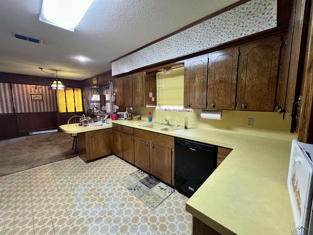 kitchen with dishwasher, kitchen peninsula, pendant lighting, a textured ceiling, and sink