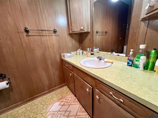 bathroom featuring wood walls and vanity