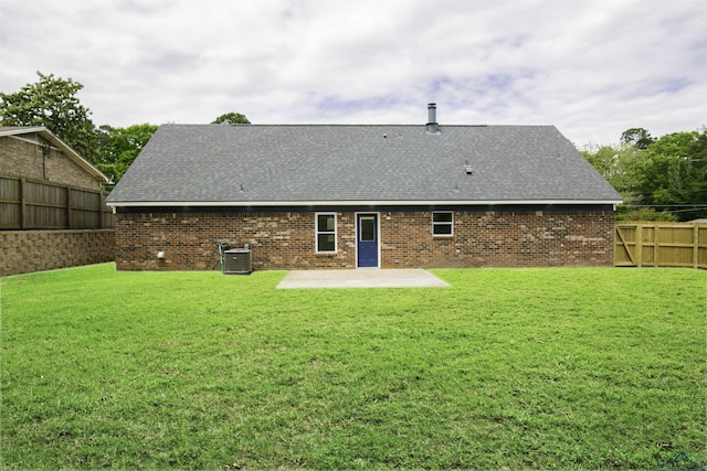 back of house with a patio, a lawn, and central air condition unit