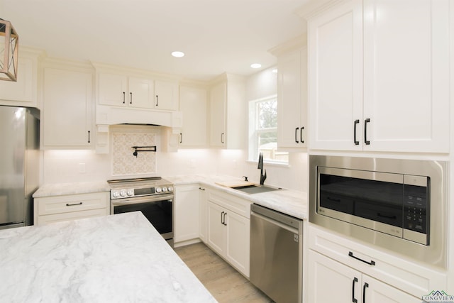 kitchen featuring white cabinetry, sink, and appliances with stainless steel finishes