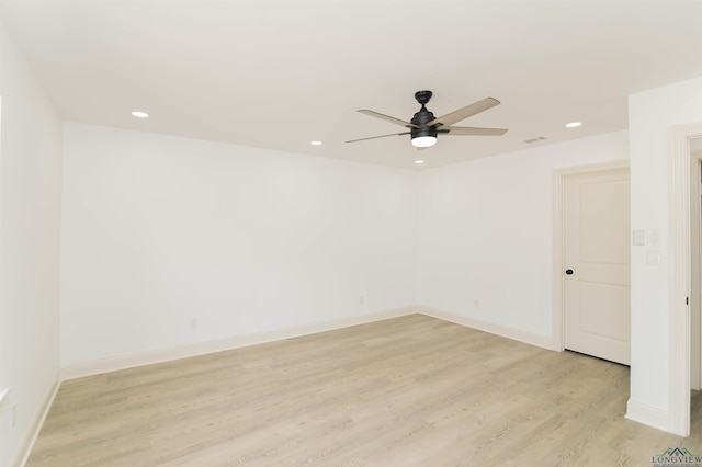 empty room with ceiling fan and light hardwood / wood-style floors