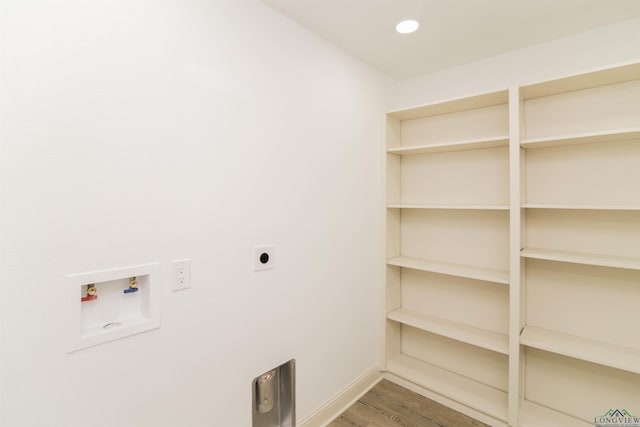 laundry area featuring electric dryer hookup, hookup for a washing machine, and hardwood / wood-style floors