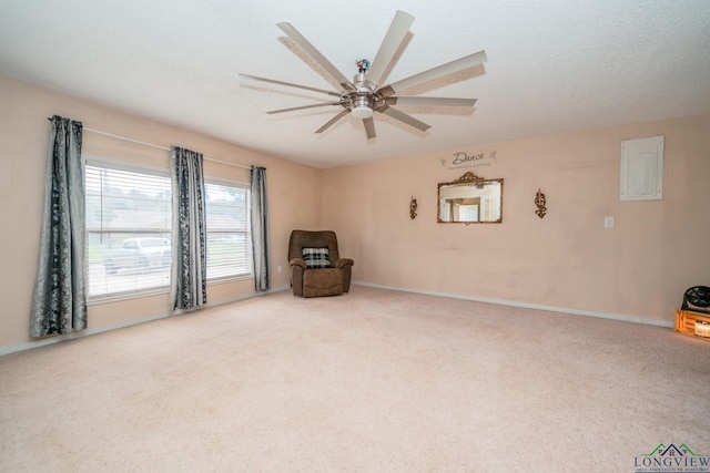 unfurnished room featuring carpet flooring, ceiling fan, a textured ceiling, and electric panel