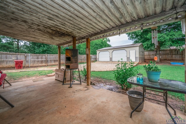 view of patio featuring an outbuilding and a garage