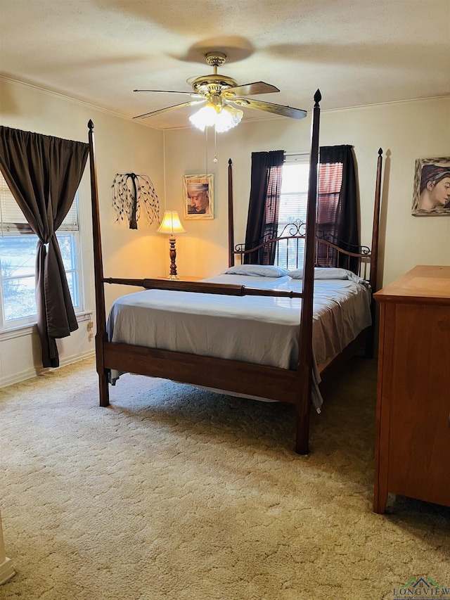 bedroom with carpet floors, ceiling fan, and multiple windows