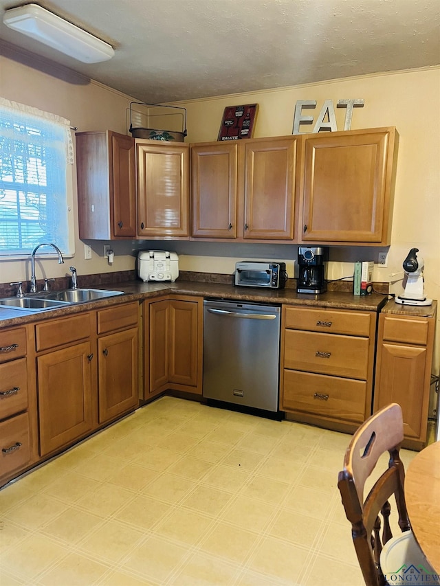 kitchen featuring sink, stainless steel dishwasher, and a textured ceiling