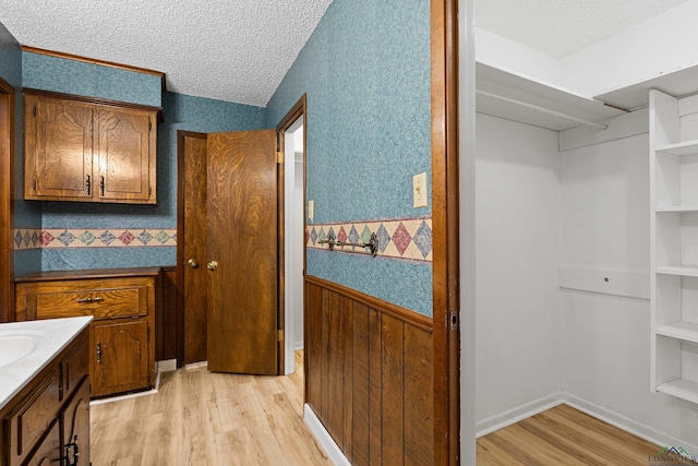 bathroom featuring hardwood / wood-style flooring and a textured ceiling