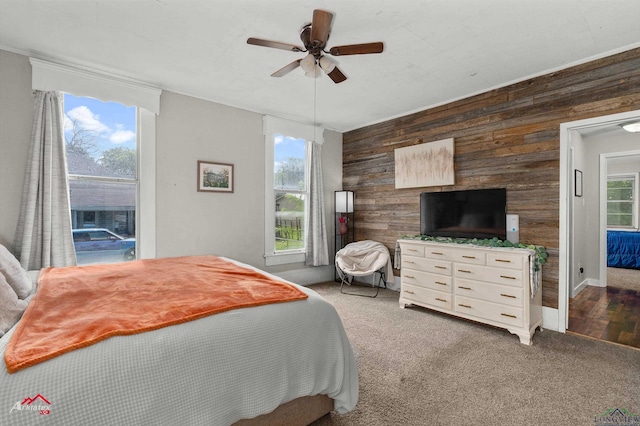102 Poplar St, Marshall, TX 75670 - carpeted bedroom featuring wood walls and ceiling fan