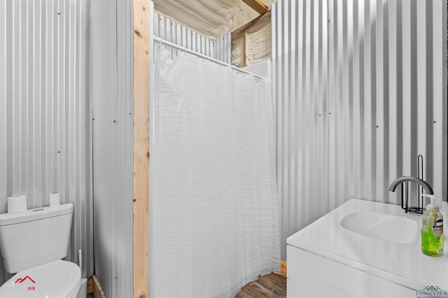 102 Poplar St, Marshall, TX 75670 - full bathroom featuring vanity, wallpapered walls, and wood finished floors