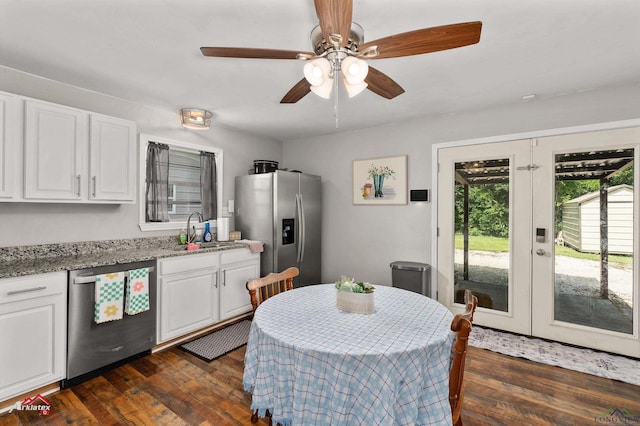 102 Poplar St, Marshall, TX 75670 - kitchen with appliances with stainless steel finishes, white cabinets, french doors, and ceiling fan