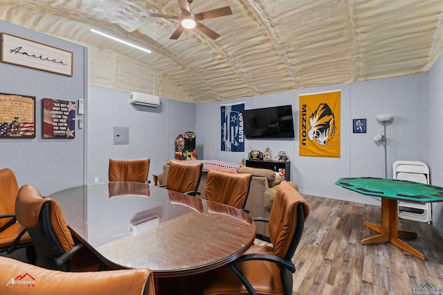 102 Poplar St, Marshall, TX 75670 - dining space featuring wood finished floors, a ceiling fan, an AC wall unit, and lofted ceiling