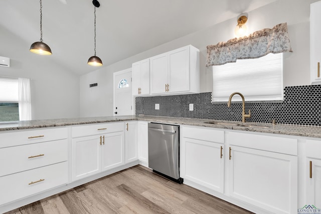 kitchen featuring sink, white cabinetry, light stone counters, stainless steel dishwasher, and pendant lighting