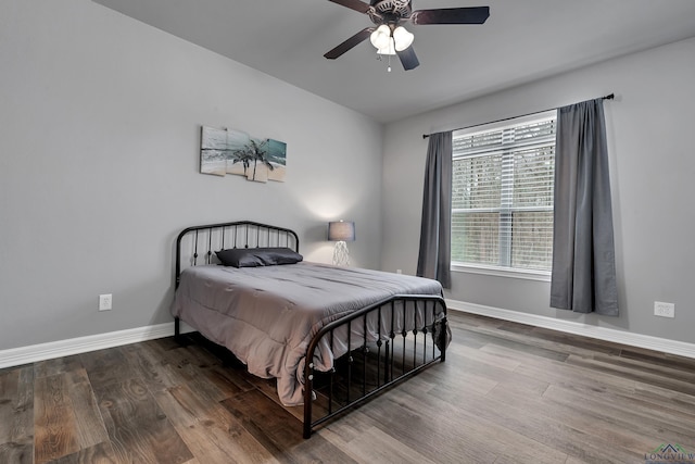 bedroom with hardwood / wood-style floors and ceiling fan