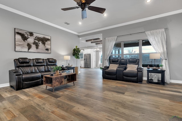 living room featuring crown molding, wood-type flooring, and ceiling fan with notable chandelier