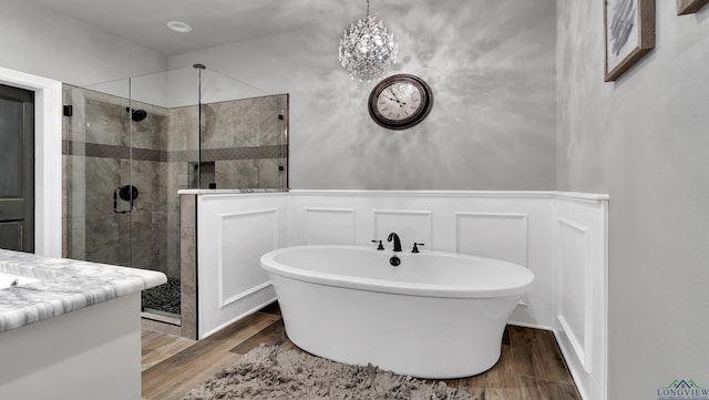 bathroom featuring independent shower and bath, vanity, and hardwood / wood-style flooring