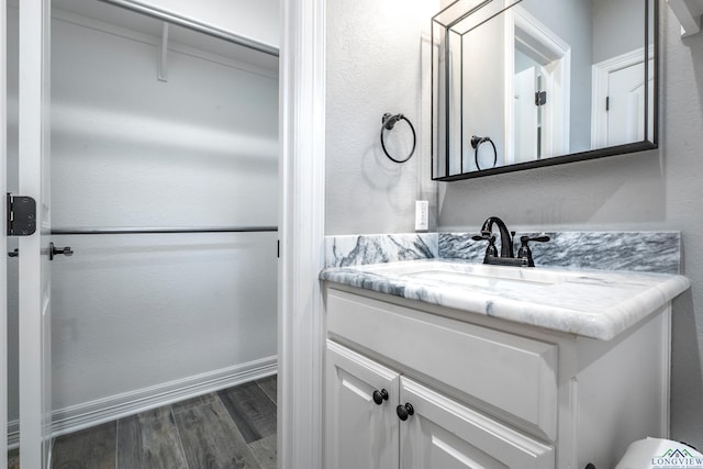 bathroom featuring hardwood / wood-style flooring and vanity