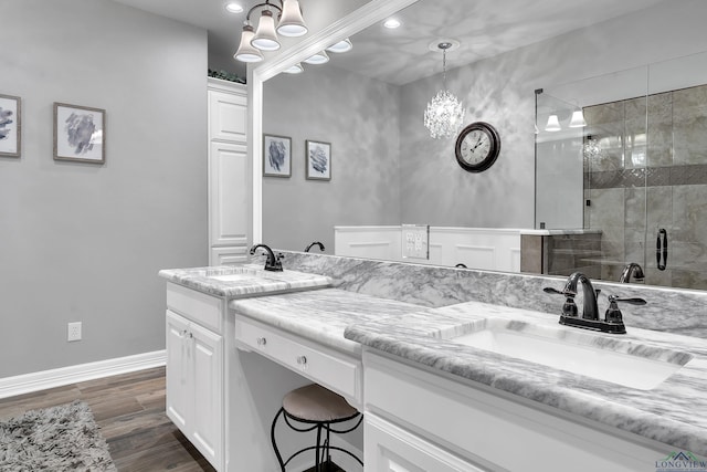 bathroom featuring vanity, wood-type flooring, and a shower with door