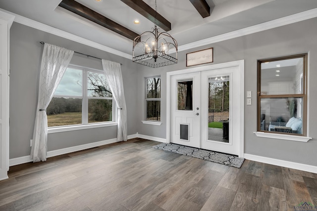 unfurnished dining area featuring an inviting chandelier, beam ceiling, wood-type flooring, and ornamental molding