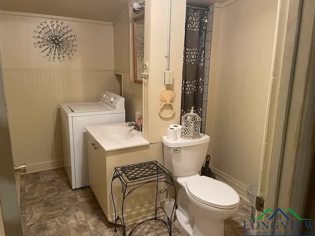 bathroom with washer / clothes dryer, sink, and toilet