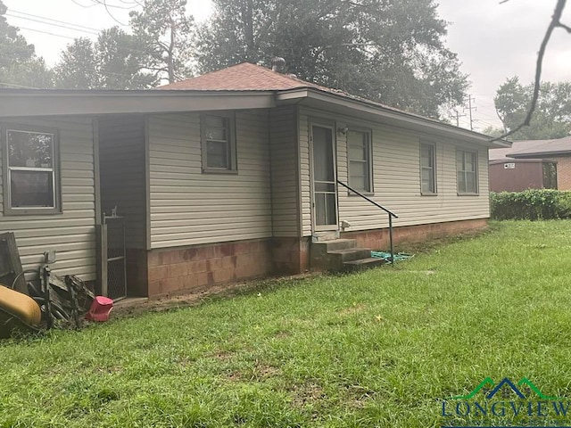 view of side of property with a lawn