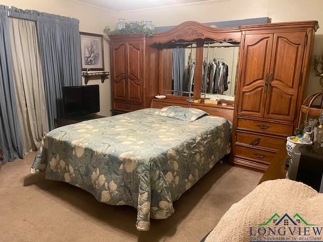 bedroom featuring light carpet