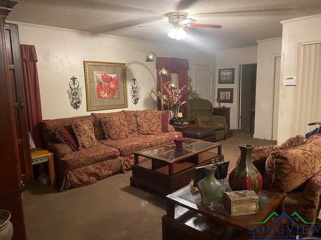 living room featuring ceiling fan, carpet floors, and a textured ceiling